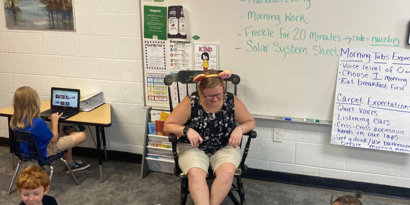 Ms. Laryssa and her class participate in independent studies with her "Donut Disturb Me" headband.