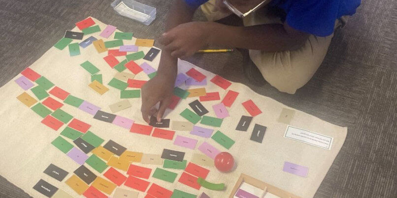 Young MMAEC student works with their Montessori materials in the classroom.